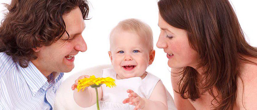 Family and baby with a flower